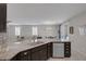 Kitchen island featuring granite countertops, stainless steel appliances, and an open view to the living room at 2827 Turnstone Ridge St, Henderson, NV 89044