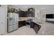 Modern kitchen with stainless steel appliances, dark cabinetry and granite countertop at 2827 Turnstone Ridge St, Henderson, NV 89044