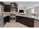 Open kitchen with granite countertops, stainless steel appliances, and view to the living room at 2827 Turnstone Ridge St, Henderson, NV 89044