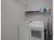 Functional laundry room featuring a modern washer and dryer and wire rack shelving at 2827 Turnstone Ridge St, Henderson, NV 89044