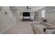 Spacious living room with large television, staircase, and tile flooring at 2827 Turnstone Ridge St, Henderson, NV 89044