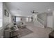 Open living area with comfortable sectional couch, tile floors, and a ceiling fan at 2827 Turnstone Ridge St, Henderson, NV 89044
