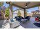 Cozy covered patio featuring comfortable seating, ceiling fan, and well-maintained landscaping at 2827 Turnstone Ridge St, Henderson, NV 89044