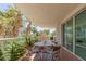 Cozy balcony features an outdoor table with mature evergreens and palm trees at 2857 Paradise Rd # 305, Las Vegas, NV 89109