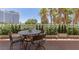 Outdoor balcony features a four-chair table with views of palm trees and a building at 2857 Paradise Rd # 305, Las Vegas, NV 89109
