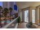 Outdoor seating on the balcony offers a view of palm trees, a pool, and city lights at 2857 Paradise Rd # 305, Las Vegas, NV 89109