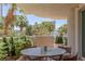 This shaded balcony has an outdoor table with mature landscaping and palm trees at 2857 Paradise Rd # 305, Las Vegas, NV 89109