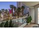 Balcony view of palm trees, pool, and city buildings, with outdoor plants for a scenic urban retreat at 2857 Paradise Rd # 305, Las Vegas, NV 89109