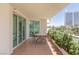 This outdoor balcony features tile floors, a table, and views of palm trees and buildings at 2857 Paradise Rd # 305, Las Vegas, NV 89109
