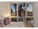 Cozy bedroom showcasing a large window with a view of palm trees and poolside at 2857 Paradise Rd # 305, Las Vegas, NV 89109