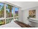 Bedroom with bright window views of palm trees and the community pool at 2857 Paradise Rd # 305, Las Vegas, NV 89109