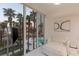 Bedroom with large windows showcasing palm trees and a pool area at 2857 Paradise Rd # 305, Las Vegas, NV 89109
