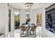 Dining area features a modern chandelier, glass table, and expansive city views at 2857 Paradise Rd # 305, Las Vegas, NV 89109