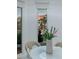 Close-up of a modern dining table decorated with flowers, showcasing the palm tree view and city skyline at 2857 Paradise Rd # 305, Las Vegas, NV 89109
