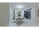 Dining room with a round table and chairs beneath a modern chandelier and views of palm trees outside at 2857 Paradise Rd # 305, Las Vegas, NV 89109