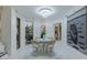 Bright dining area with a round table, stylish chairs, and large windows overlooking palm trees and greenery at 2857 Paradise Rd # 305, Las Vegas, NV 89109