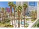 Overhead of a palm tree lined pool and lounge area surrounded by city buildings at 2857 Paradise Rd # 305, Las Vegas, NV 89109