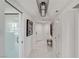 Hallway featuring white tile floors, modern lighting, and elegant artwork, leading to a comfortable living space at 2857 Paradise Rd # 305, Las Vegas, NV 89109