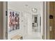 Bright hallway featuring white tile floors, modern lighting, and elegant artwork, leading to a comfortable living space at 2857 Paradise Rd # 305, Las Vegas, NV 89109