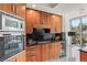 Gourmet kitchen with wood cabinetry, granite countertops, and stainless appliances, including a wine fridge at 2857 Paradise Rd # 305, Las Vegas, NV 89109