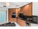 Well-lit kitchen features wood cabinets, dark countertops, and stainless steel appliances at 2857 Paradise Rd # 305, Las Vegas, NV 89109