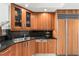 Bright kitchen with wood cabinets, black countertops, and stainless steel appliances at 2857 Paradise Rd # 305, Las Vegas, NV 89109