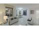 Bright living and dining room with modern decor, balcony access, and views of palm trees from the sliding glass doors at 2857 Paradise Rd # 305, Las Vegas, NV 89109