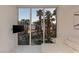 Bright living room with large windows showcasing palm trees and a poolside view at 2857 Paradise Rd # 305, Las Vegas, NV 89109
