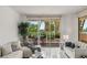 Bright living room with access to a terrace, featuring contemporary sofas, neutral decor, and ample natural light at 2857 Paradise Rd # 305, Las Vegas, NV 89109