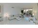 Airy living space featuring a modern sectional sofa, sleek tile flooring, and a sliding glass door to the balcony at 2857 Paradise Rd # 305, Las Vegas, NV 89109