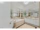 Lavish bathroom featuring a tub, mirrored walls, and vanity with marble countertops at 2857 Paradise Rd # 305, Las Vegas, NV 89109