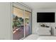 Bright main bedroom with access to a tiled balcony and outdoor seating at 2857 Paradise Rd # 305, Las Vegas, NV 89109