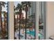 Scenic pool view through large windows, surrounded by palm trees and lounge chairs at 2857 Paradise Rd # 305, Las Vegas, NV 89109
