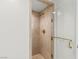 Modern bathroom shower featuring tan tile and gold hardware with a glass door at 2857 Paradise Rd # 305, Las Vegas, NV 89109