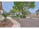 Backyard with stone pathway and lush greenery creating a peaceful outdoor space at 3104 Archwood Way, Las Vegas, NV 89134