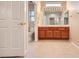 Well-lit bathroom with double vanity, tiled floors, and decorative mirror at 3104 Archwood Way, Las Vegas, NV 89134