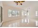 Spacious dining area with tile flooring, multiple windows, and a ceiling fan at 3104 Archwood Way, Las Vegas, NV 89134