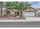 Inviting single-story home with manicured landscaping and a spacious driveway leading to a two-car garage at 3104 Archwood Way, Las Vegas, NV 89134
