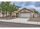 Charming single-story home with a two-car garage, desert landscaping, and a tile roof at 3104 Archwood Way, Las Vegas, NV 89134