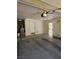 Spacious two-car garage featuring concrete flooring and plenty of storage at 3104 Archwood Way, Las Vegas, NV 89134