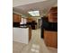 Well-lit kitchen boasts wood cabinets, black countertops, and modern appliances at 3104 Archwood Way, Las Vegas, NV 89134