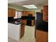 Well-lit kitchen features wood cabinets, black countertops, and modern appliances at 3104 Archwood Way, Las Vegas, NV 89134