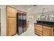 Bright kitchen with wood cabinetry, black countertops, and a seamless transition to the breakfast nook at 3104 Archwood Way, Las Vegas, NV 89134