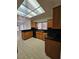 Kitchen with wood cabinets, granite countertops, and tile flooring at 3104 Archwood Way, Las Vegas, NV 89134