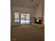 Bright living room showcasing a fireplace and backyard access through sliding glass doors at 3104 Archwood Way, Las Vegas, NV 89134