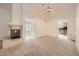 Inviting living room with a fireplace, chandelier, and seamless flow into the kitchen area at 3104 Archwood Way, Las Vegas, NV 89134