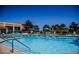 Community outdoor pool featuring seating areas and beautiful sky views at 3104 Archwood Way, Las Vegas, NV 89134