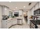 Bright kitchen with granite countertops, stainless steel appliances, and light wood flooring at 314 Abbington St, Henderson, NV 89074