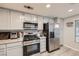 Kitchen with stainless steel appliances, granite countertops, and light wood flooring at 314 Abbington St, Henderson, NV 89074
