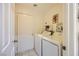 Laundry room with washer, dryer, and door to hallway at 314 Abbington St, Henderson, NV 89074